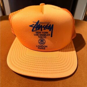 Stussy Vibrant Orange trucker Cap with navy Blue Logo
